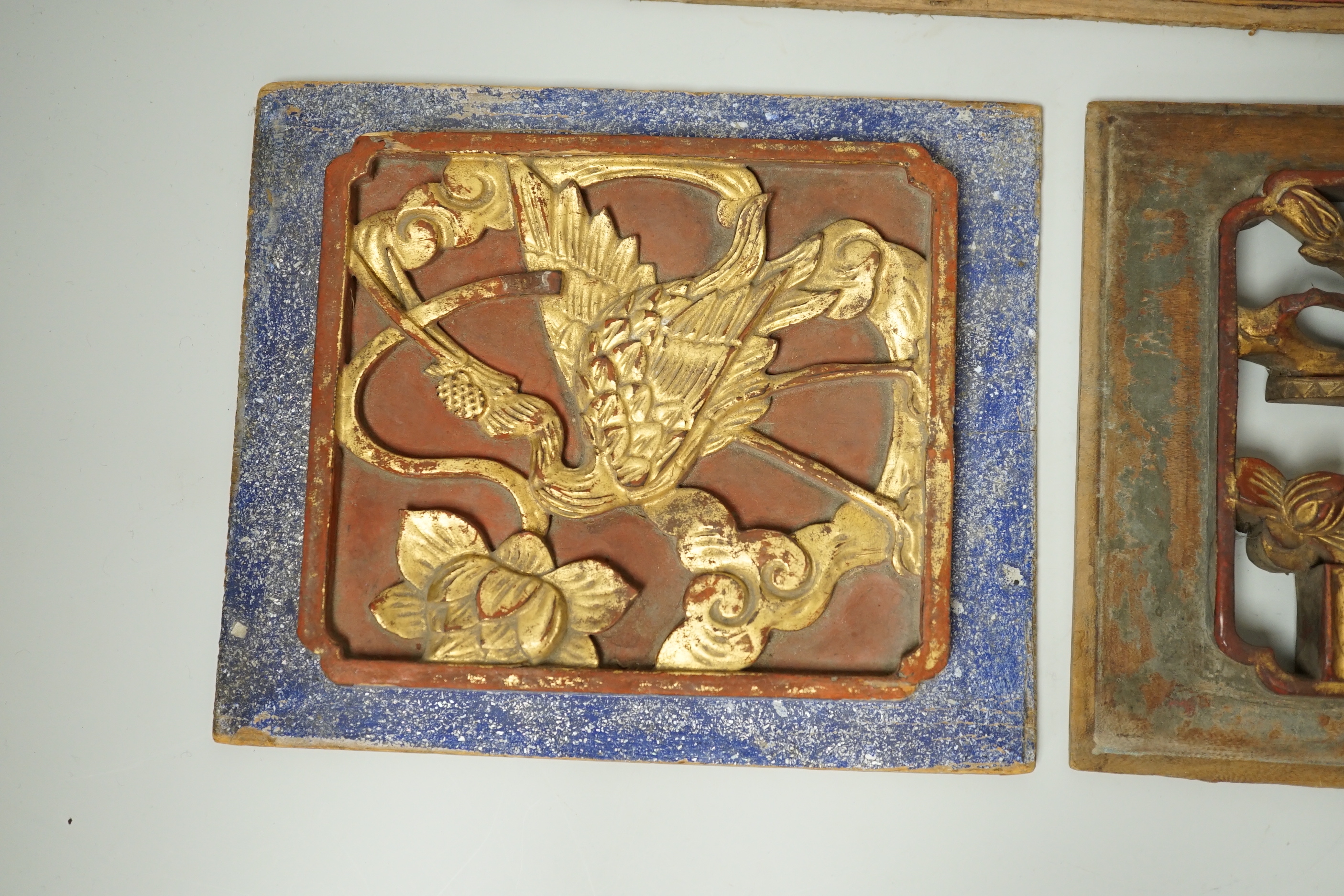 Three Chinese gilded and lacquered wood panels, early 20th century, longest 31cm